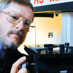 A man inspects laser-applied product labeling