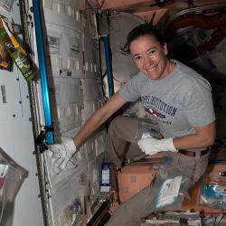 NASA astronaut Megan McArthur collects microbial samples from surfaces inside the space station