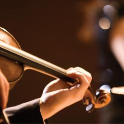 Closeup of hands playing a violin