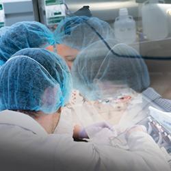 Two SpaceLab technicians in protective gear prepare a CubeLab experiment